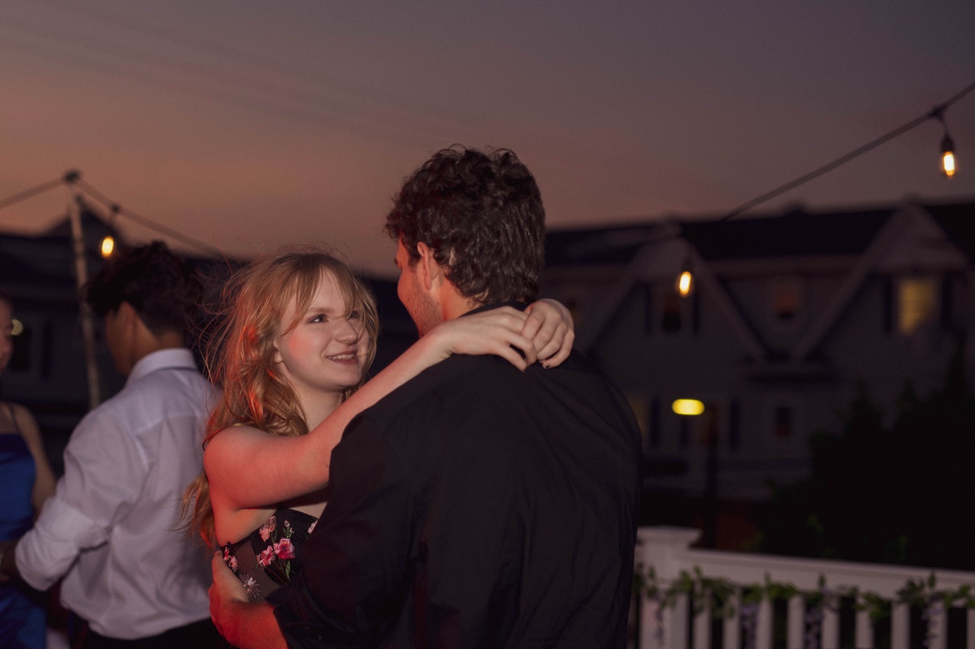 A couple slow-dancing at sunset