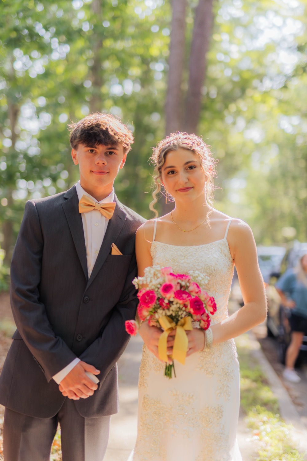 A couple in formalwear with a bouquet